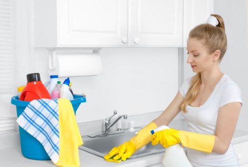 Staff member handling cleaning products safely